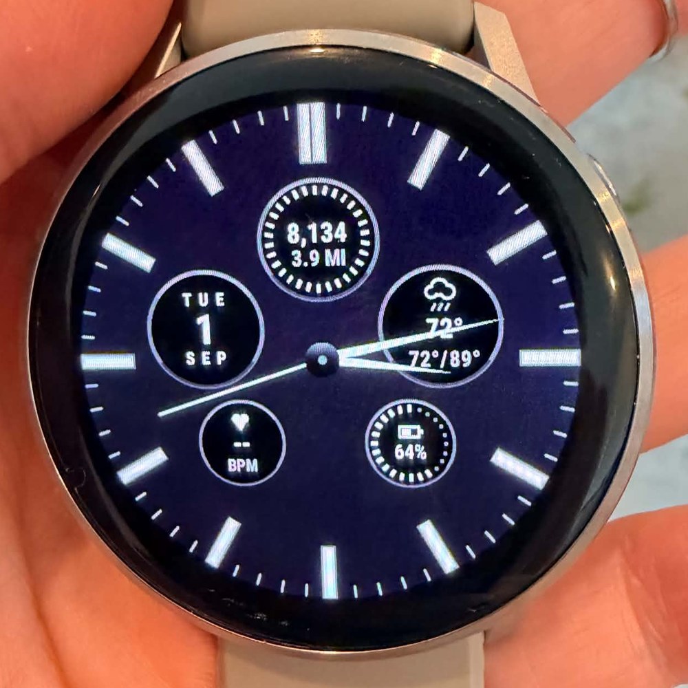 The FIELD watch face running on a Garmin Venu 4, showing step count, weather, battery, heart rate and date sub-dials around analog hands